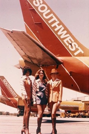 Photo of three beautiful Southwest Airlines stewardesses with long lean legs.