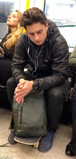 Eye Candy: photo of good-looking young man with ipod on London Underground.